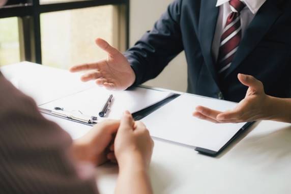 A person in a suit talking to a person